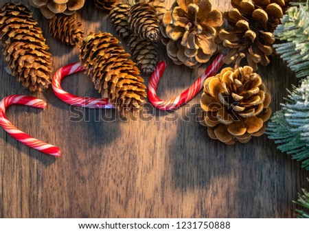 Christmas wooden background with wreath, pinecones and candy canes with copy space 