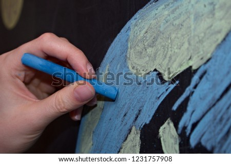 drawing of planet earth with chalk on a blackboard