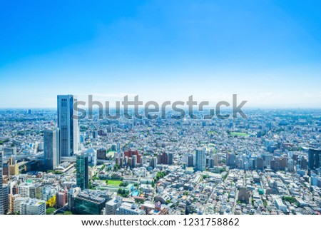 Asia Business concept for real estate and corporate construction - panoramic modern city skyline aerial view of shinjuku area under bright blue sky and sun in Tokyo, Japan