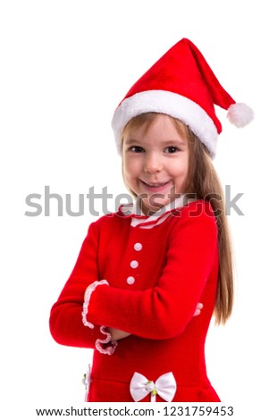 Smiling coquettish christmas girl wearing a santa hat isolated over a white background. Portrait picture