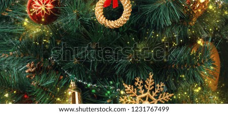 Greeting card with the wish "Merry Christmas" in English against the background of decorated branches of the Christmas fir with magic dust in retro style