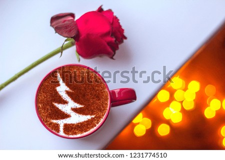 Cappuccino cup with cinnamon Christmas tree symbol on milk froth