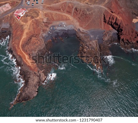 Aerial view of waves crashing on a rock formation. Playa El Golfo. Black beach of the Charco de los Clicos. Lanzarote, Canary Islands, Spain