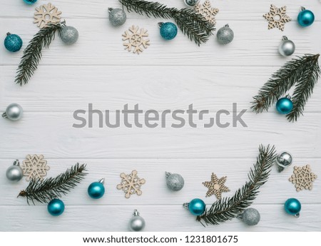 Christmas fir tree with decoration and glitters on wooden background. Christmas background on the white wooden desk