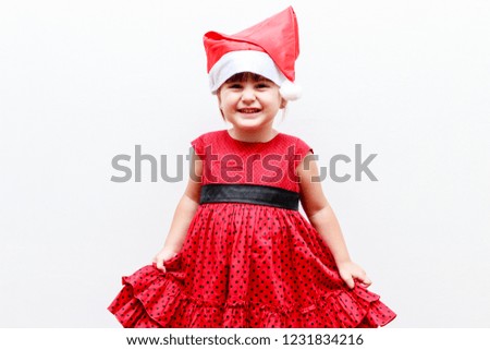 portrait of caucasian toddler girl with christmas hat, white background