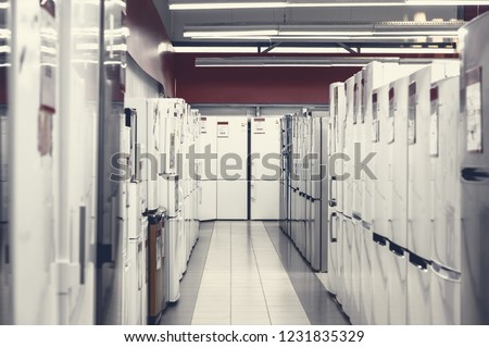 Rows of white and silver fridges in appliance store's showroom Royalty-Free Stock Photo #1231835329