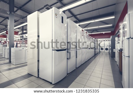 Rows of fridges and washing mashines in appliance store Royalty-Free Stock Photo #1231835335