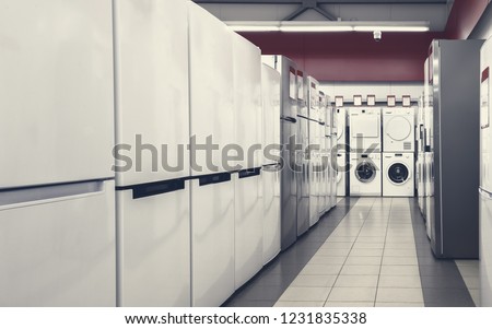 Rows of fridges and washing mashines in appliance store Royalty-Free Stock Photo #1231835338