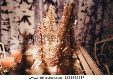 Christmas Firs in Rose Gold Glitter Detail Bokeh Miniature with a Wooden Background