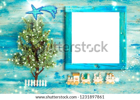 Christmas Nativity photo frame greetings. Christmas tree and vintage style wooden train with empty photo frame to put photo or message