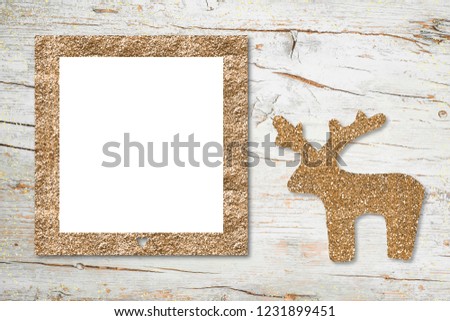 Christmas Nativity photo frame card. Silhouette of reindeer and frame to put photo made with ocher glitter on an old wooden background