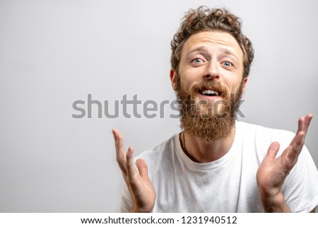 Friendly positive man looking at camera with doubting, questioning expression as if he does not know what to say anything else. Isolated shot of adorable man over white background with copyspace