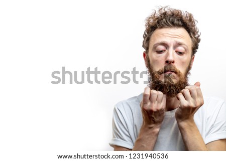 Picture of clueless young bearded European man, with fair hair feeling confusion or regret becouse not fulfil his promise.
