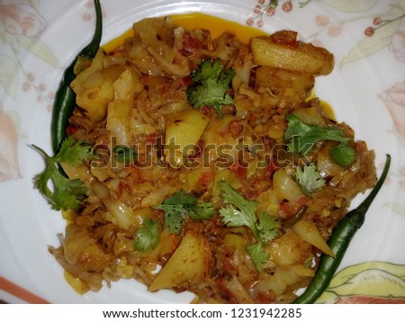 Pakistani Cabbage and potato curry . Selective focus on a front edge of the plate