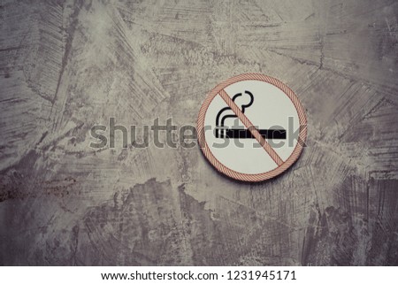 No smoking sign on the gray cement wall background