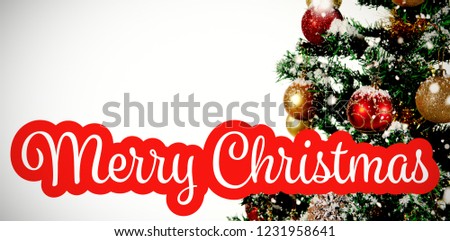 White and red greeting card against christmas decorations hanging in tree