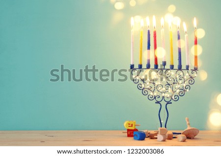 image of jewish holiday Hanukkah background with menorah (traditional candelabra) and colorful candles.