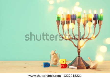 image of jewish holiday Hanukkah background with menorah (traditional candelabra) and colorful candles