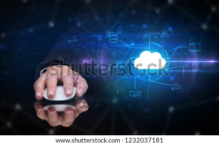 Hand using wireless mouse in a dark environment with cloud technology and online storage concept
