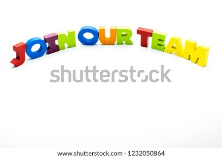 Join Our Team text written with colourful wooden letters, isolated over white with copy space on the bottom. Business concept