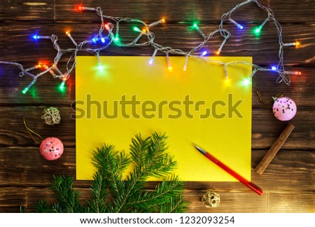 Christmas tree branch, garland, cones, a clean sheet and a fountain pen on the  wooden boards. Color template for cards and greetings. Merry Christmas and Happy New Year - 2019!                  