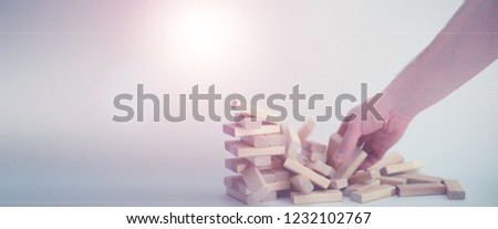 Board game brick tower of light wood sticks
