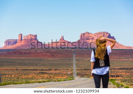 Woman at the road in Monument Valley Royalty-Free Stock Photo #1232109934