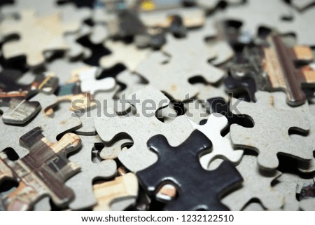 
Close up piece of wooden jigsaw puzzle as a concept of business success in challenge completion with teamwork. Selective focus of pieces jigsaw puzzle background.