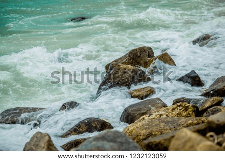 The background of the sea waves splashed across the rocks at the beach, a period of storms and winds blowing all the time.