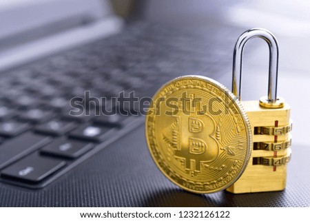 Protect bitcoin wallet concept, golden padlock and bitcoin coin on keyboard