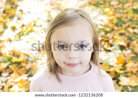 Autumn portrait of beautiful little girl