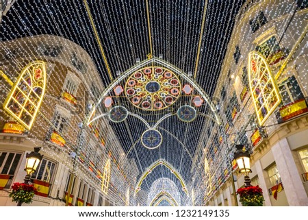 Details of Christmas decorations on Calle Marques de Larios street in the centre of Malaga city, Andalusia, Spain. Most popular pedestrian street of Malaga Royalty-Free Stock Photo #1232149135