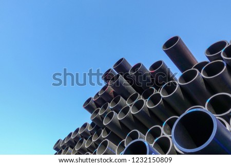 Plastic pipes in stock of finished products stacked in packs Royalty-Free Stock Photo #1232150809