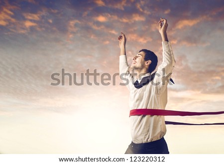 Young businessman crossing the finish line Royalty-Free Stock Photo #123220312