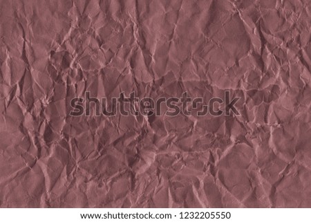 Old red grunge paper texture. Vintage background for design and scrapbooking. Old, compressed and crumpled effect.
