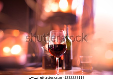 wine red in glass on the bar, out of focus