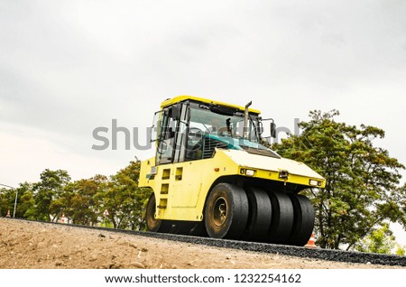 Close view on the road roller working on the new road construction site