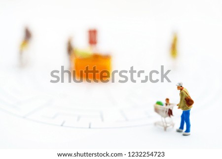 Miniatrue people: Shoppers buy goods on sale with discount tray. Tourism, shopping or business concept.