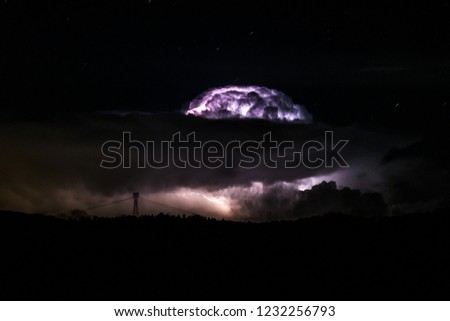 Lightning storm in the clouds in the distance
