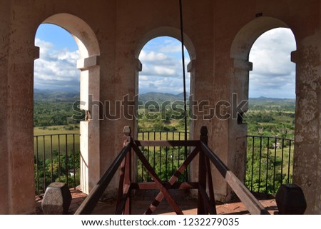 view from the slave watch tower  Torre de Manaca Iznaga near Trinidad Cuba. green trees and mountains in the background.