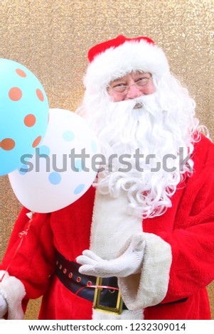 Santa Claus. Santa Claus holds Balloons. Merry Christmas Balloons. Helium Balloon. Gold Sequin Background. 
