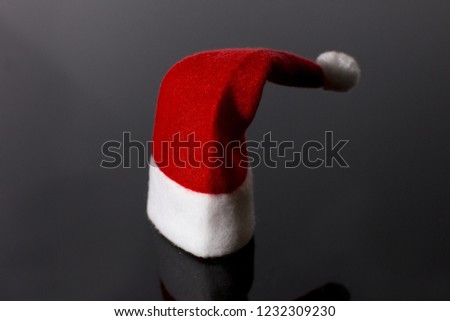 New year's red cap of Santa Claus. red white on black background.