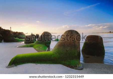 beautiful sea view with unique rock formation scenery over stunning sunrise and cloudy sky background.