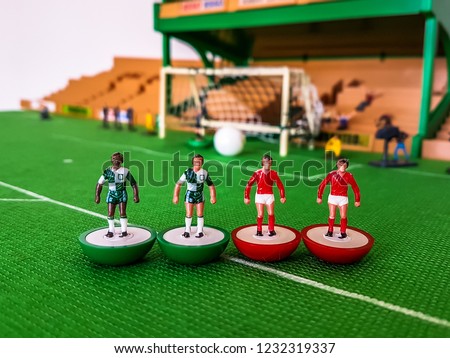 Subbuteo football figures lined up in front of the goal on a grass field, Liverpool v Manchester United
