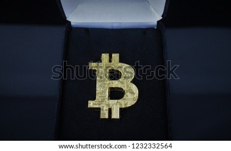 Gold Bitcoin (BTC) symbolically inside jewelry case. 3D Bitcoin B with circuitry