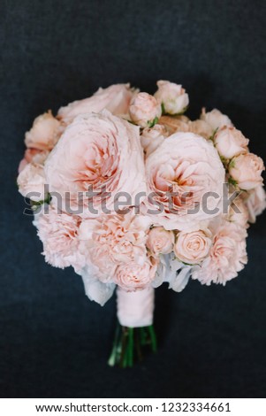 Bride's wedding bouquet with pink roses and peonies.