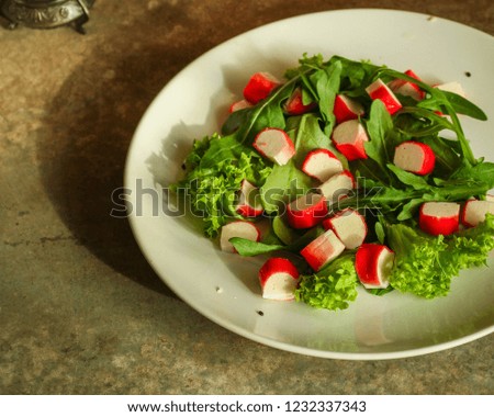 fresh salad lettuce leaves and crab sticks. top view. copy space
