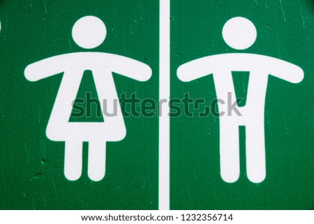 Public restroom toilet WC sign man and woman in green