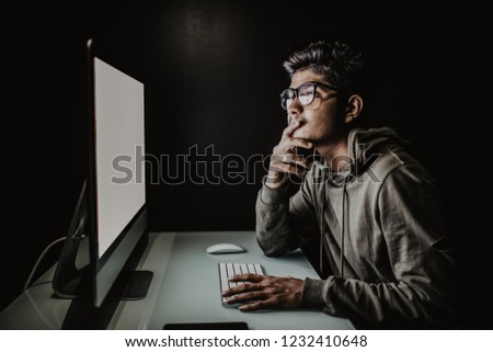 Indian hacker using computer white screen trying to commit computer crime.