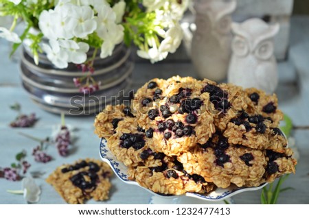 Oatmeal cookies with berries on a wooden background